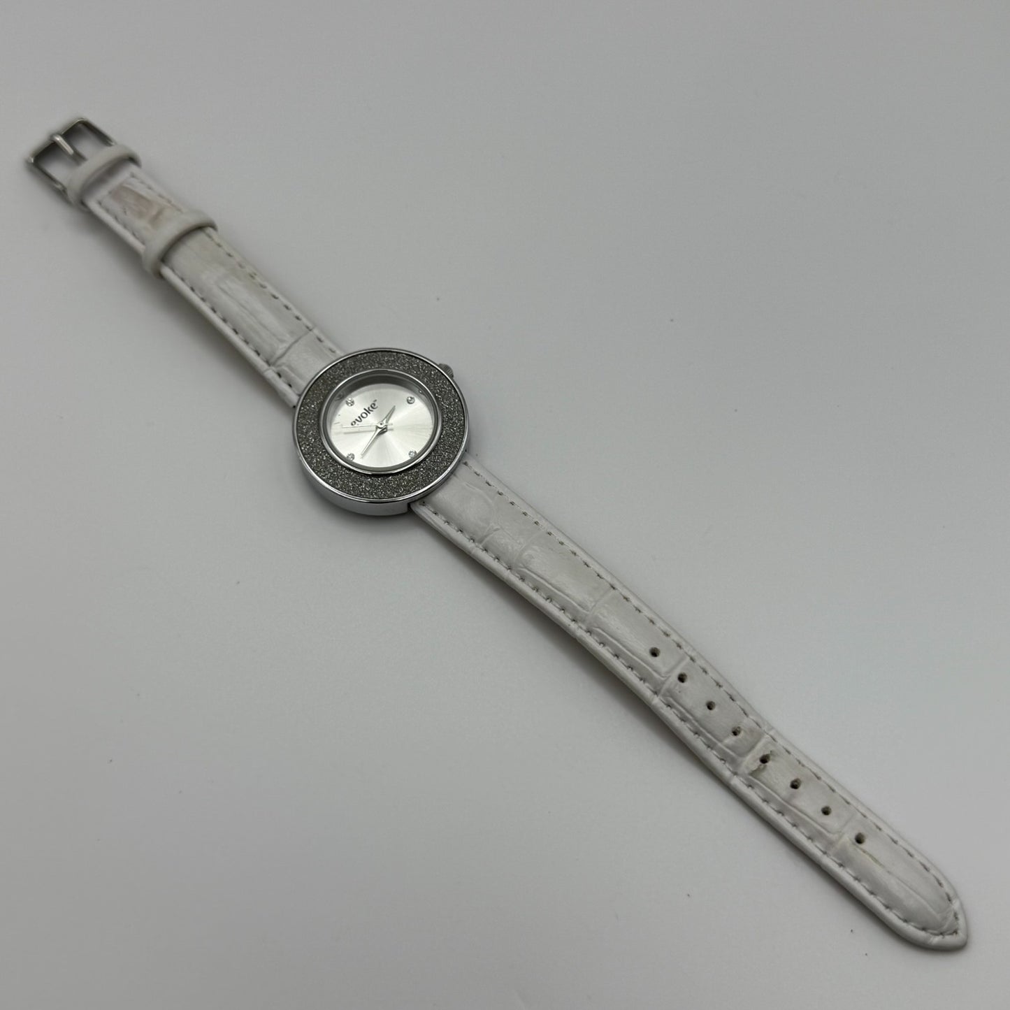 Evoke Ladies Quartz Watch Silver Dial Glitter Bezel White Strap Working 30mm